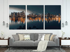 Captivating downtown Vancouver canvas print showcasing illuminated skyscrapers mirrored in still waters, delivering a contemporary urban artwork vibe.