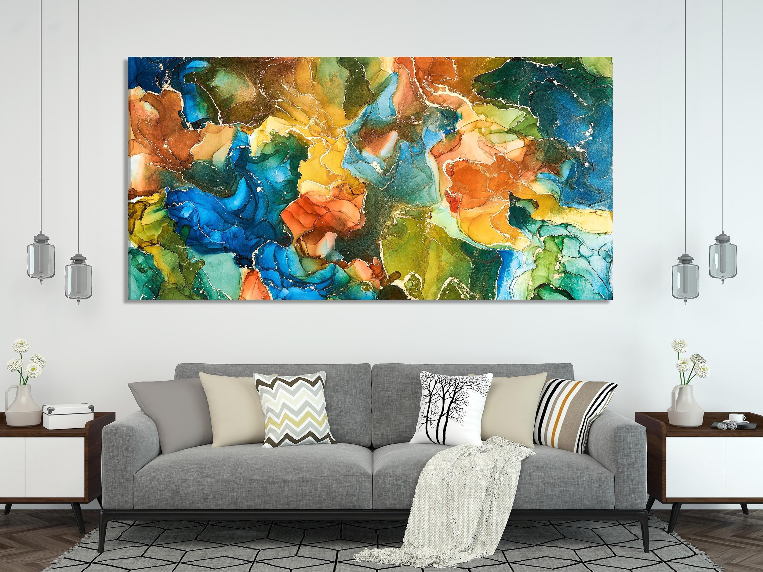 Alcohol ink wall art above a sofa—blue, green and orange abstract canvas print