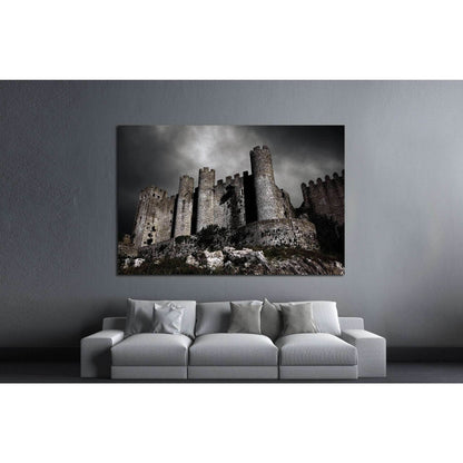 Medieval Castle Under Brooding Sky Canvas Print for Historic DecorThis canvas print portrays an imposing medieval castle set against a dramatic sky, evoking a sense of history and timeless strength. The moody atmosphere captured in this image makes it a c