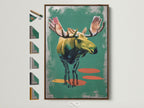 Artwork of a moose in a brown frame. The art is matted and ready to hang. A variety of frame options are displayed. Find the perfect frame to match your unique style. Transform your living space with framed artwork.