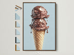 A tempting chocolate ice cream cone artwork is displayed in a brown frame. The artwork is mounted on a wall. This photo showcases all available frame options. Enhance your space with this delicious looking piece.