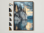 Lakeside Cliff canvas print with brown frame. Frame options are displayed on the side. This serene mountain wall art brings a moody landscape to your study room decor. The nature artwork features blue and gray hues. Reflective art creates a tranquil scene with a mountain painting reflected in water.
