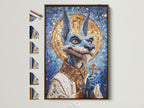 Anubis Mosaic Artwork Print with a brown frame. The artwork is an Egyptian God Wall Art piece. It features blue and gold religious imagery. Perfect gothic art for office wall decor. It can be customized with various frame options available on the side.