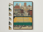 A framed Urban Tennis Court artwork hangs on a white wall. The brown frame complements the mid-century style. Other frame options are displayed. This vintage city sports art adds retro charm to any room. It's perfect sports wall decor.