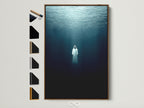A brown frame displays underwater figure artwork. All frame options are showcased on the side. This ethereal wall art brings a moody ocean theme. It's perfect for a meditation space or as spiritual decor. Elevate your space with this tranquil print.