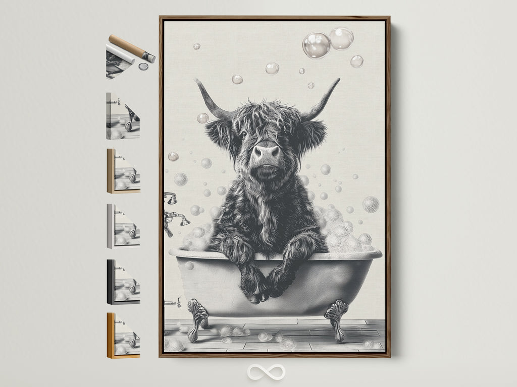 A framed Highland Cow art print is displayed on a white wall. The artwork features a black and white image of a cow relaxing in a bathtub filled with bubbles. The frame is a light brown wood color. It complements Country Farmhouse style bathroom art or wall decor.