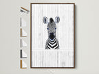 Baby Zebra artwork in a brown frame. The artwork is displayed on a wall. Various frame options are showcased beside the framed zebra art. Ideal for minimalist and contemporary spaces. Perfect nursery wall art.