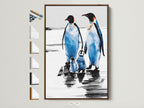 Penguin Family Art Print in a brown frame. This arctic wildlife canvas art is perfect coastal wall decor for a nursery. It is also a great gift for any animal lover. The frame options are displayed on the side.