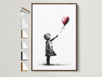 Explore framed art prints. This image showcases a Banksy-inspired piece with a girl reaching for a heart-shaped balloon. This artwork is displayed in a brown frame. Discover various frame options to perfectly match your style. Elevate your home decor with our unique framed artwork.