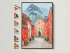 Village Street artwork in a brown frame. See all available frame options for this vintage style architecture poster. Find the perfect frame to complement your red and peach wall art. Elevate your entryway decor with this charming piece of travel art.