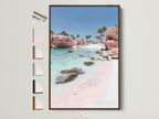 Pink Sand Beach artwork in a brown frame. The wall art captures a serene coastal scene. Turquoise water meets a blush pink beach. See frame options to customize your coastal artwork.