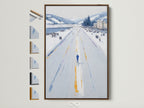 Winter Cityscape artwork in a brown frame hangs on a white wall. Several frame options are displayed beside it. This cool-toned minimalist art enhances living rooms bedrooms offices studios lobbies clinics cafés and boardrooms. Elevate your decor with this snowy street print.