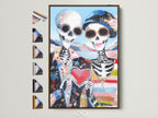 Dia de los Muertos couple art displayed in a brown floating frame. This folk art print features sugar skulls a heart and colorful details. See all frame options to find the perfect Day of the Dead wall art.