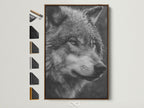 A captivating wolf portrait in black and white. The artwork features a brown frame. See all available frame options to perfectly match your decor. Enhance your living space with this striking wildlife canvas art.