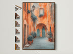 Italian Village artwork in a brown frame displayed on a white wall. Various frame options are showcased beside it. The artwork captures Tuscan architecture with warm tones. A perfect piece of travel photography for office decor.