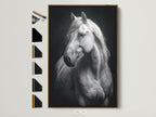 Equestrian wall art featuring a white horse in black and white. The artwork is framed in a natural brown frame. See all frame options available for this animal canvas. Perfect horse art for bedroom wall decor or farmhouse style. A black and white print adds elegant equine art to any space.