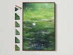 Brown frame is displayed. All frame options are on the side. A swan swims peacefully in a pond. The artwork has a vibrant green hue. The art is framed in a brown frame. It adds a touch of nature to the room.