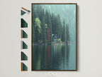 Lakeside Cabin artwork with a brown frame is displayed. The artwork shows a green cabin by a lake surrounded by green pine trees. There's a red tree adding a pop of color. Frame options are visible on the side. This moody green nature photography is perfect for a study or cabin decor.