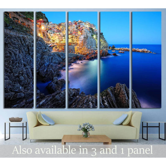 Manarola Cinque Terre Canvas Print - Italian Riviera Wall ArtThis multi-panel canvas print captures the picturesque village of Manarola, part of the Cinque Terre on the Italian Riviera. The vibrant houses perched atop the rugged cliffside, overlooking the