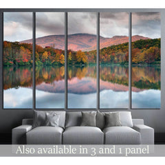 Blue Ridge Parkway Autumnal Mountain View Canvas Art for Modern OfficesThis canvas print depicts a peaceful lake reflecting the fiery hues of autumn trees and the soft purple of the mountain backdrop. The mirrored colors in the water create a sense of har