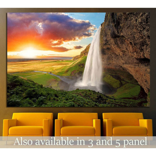 Seljalandsfoss Waterfall Sunset Canvas Print - Majestic Iceland Wall ArtThis canvas print stunningly captures the majestic Seljalandsfoss waterfall in Iceland, set against a striking sunset that bathes the landscape in warm, golden light. The powerful cas