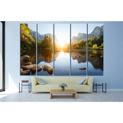 Granite Cliffs and River Reflection Wall Decor - Yosemite Landscape ArtworkThis canvas print offers a stunning portrayal of Yosemite Valley at sunrise, with the sun's first rays illuminating the granite cliffs and casting reflections on the calm waters of